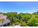 Exterior view of the condo building surrounded by lush greenery and blue sky at 311 71St Ave. N # 5A, Myrtle Beach, SC 29572
