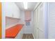 Hallway features white cabinets, a red countertop and a closet, providing ample storage and functionality at 311 71St Ave. N # 5A, Myrtle Beach, SC 29572