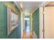 Hallway features a tiled floor, textured green walls, and modern lighting fixtures at 311 71St Ave. N # 5A, Myrtle Beach, SC 29572