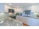 Bright kitchen featuring white cabinets, granite countertops, stainless steel appliances, and a tiled backsplash at 311 71St Ave. N # 5A, Myrtle Beach, SC 29572
