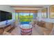 Stylish living room with balcony access and comfortable seating, offering scenic views of lush trees at 311 71St Ave. N # 5A, Myrtle Beach, SC 29572