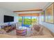 Charming living room with large windows leading to an outdoor balcony space and comfortable seating at 311 71St Ave. N # 5A, Myrtle Beach, SC 29572