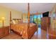 Well-lit bedroom with a view to the outside from the balcony, a wooden bed, and matching wooden furniture at 311 71St Ave. N # 5A, Myrtle Beach, SC 29572