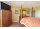 Well-lit bedroom featuring a large bed with wooden posts, wooden furniture, and terracotta-style tiled floors at 311 71St Ave. N # 5A, Myrtle Beach, SC 29572