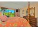 Bedroom with king-size bed, hardwood floors, a balcony and an exterior view of palm trees and other vegetation at 311 71St Ave. N # 5A, Myrtle Beach, SC 29572