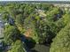 Stunning aerial view highlighting the property's waterfront location amidst lush greenery and a tranquil canal at 314 Trace Run, Myrtle Beach, SC 29588