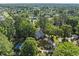 An aerial view showcases this charming single-Gathering home with a pool surrounded by mature trees and green lawns at 314 Trace Run, Myrtle Beach, SC 29588