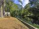 View of backyard with a canal with a wooden divider that creates a serene landscape at 314 Trace Run, Myrtle Beach, SC 29588