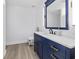 Bathroom featuring a navy vanity with gold hardware and a matching framed mirror at 314 Trace Run, Myrtle Beach, SC 29588