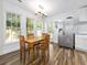 Sunlit dining area features wood table and chairs, stainless fridge, and backyard views at 314 Trace Run, Myrtle Beach, SC 29588