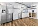 Kitchen featuring stainless steel appliances, white cabinets, a marble backsplash, and hardwood floors at 314 Trace Run, Myrtle Beach, SC 29588
