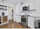 Well-lit kitchen features stainless steel appliances, marble countertops, and convenient access to laundry area at 314 Trace Run, Myrtle Beach, SC 29588