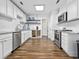 Well-lit kitchen featuring stainless steel appliances, white cabinets, and elegant hardwood floors at 314 Trace Run, Myrtle Beach, SC 29588