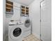 A clean laundry room with a modern washer and dryer, paired with sleek cabinetry for ample storage at 314 Trace Run, Myrtle Beach, SC 29588