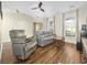 Cozy living room with hardwood floors, a ceiling fan, and comfortable gray leather seating furniture at 314 Trace Run, Myrtle Beach, SC 29588