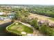 Aerial view of a golf course with sand traps and residential homes with mature tree coverage at 3157 Hermitage Dr., Little River, SC 29566