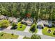 Aerial view of the home, showcasing its well-maintained landscaping, driveway, and proximity to surrounding trees at 3157 Hermitage Dr., Little River, SC 29566