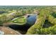 Aerial view of a golf course featuring sand traps and a dark water hazard at 3157 Hermitage Dr., Little River, SC 29566