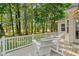 Inviting backyard deck with white railings and comfortable seating, surrounded by lush greenery and trees at 3157 Hermitage Dr., Little River, SC 29566