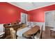 Bright dining room featuring vibrant red walls, hardwood floors, and classic furnishings at 3157 Hermitage Dr., Little River, SC 29566
