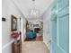 Inviting entryway with chandelier leading to the living room with fireplace and hardwood floors at 3157 Hermitage Dr., Little River, SC 29566