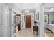 Grand entryway with tiled floors, chandelier, and views into the bedroom and dining room at 3157 Hermitage Dr., Little River, SC 29566