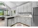 Eat in kitchen with granite counters, stainless appliances and arched window at 3157 Hermitage Dr., Little River, SC 29566