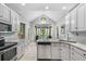 Open eat in kitchen with granite countertops, stainless appliances and arched window at 3157 Hermitage Dr., Little River, SC 29566