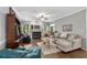 Cozy living room with a fireplace, hardwood floors, and comfortable seating arrangement at 3157 Hermitage Dr., Little River, SC 29566