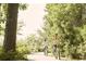 Active community members enjoy a bike ride along the paved trail surrounded by trees at 352 Magnolia Terrace Dr, Myrtle Beach, SC 29579
