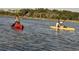Active community members enjoy kayaking in the calm waters on a sunny day at 352 Magnolia Terrace Dr, Myrtle Beach, SC 29579