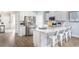 Bright kitchen features stainless steel appliances, white cabinetry, a large island, and wood flooring at 352 Magnolia Terrace Dr, Myrtle Beach, SC 29579