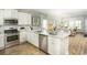 Modern kitchen featuring white cabinets, stainless steel appliances, and an open layout with hardwood floors at 352 Magnolia Terrace Dr, Myrtle Beach, SC 29579