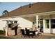 Covered outdoor patio with dining furniture and an outdoor kitchen for entertaining friends and Gathering at 352 Magnolia Terrace Dr, Myrtle Beach, SC 29579