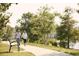 Peaceful walking path near the water's edge with mature landscaping and comfortable bench seating at 352 Magnolia Terrace Dr, Myrtle Beach, SC 29579
