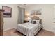 Comfortable bedroom features neutral decor, a cozy bed with decorative pillows, and a window for natural light at 380 Rookroost Circle, Conway, SC 29526