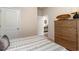 This bedroom features a wooden dresser and view into the foyer, providing natural light to the space at 380 Rookroost Circle, Conway, SC 29526