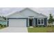 Charming single-story home featuring blue siding, white trim, attached garage, and well-maintained landscaping at 380 Rookroost Circle, Conway, SC 29526
