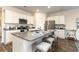 Bright kitchen with granite countertops, stainless steel appliances, white cabinets, and island with seating at 380 Rookroost Circle, Conway, SC 29526