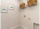The laundry room features a laundry hookup and wire shelving for storage, complemented by framed artwork at 380 Rookroost Circle, Conway, SC 29526