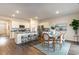 Open-concept living space features a large kitchen island and a dining table at 380 Rookroost Circle, Conway, SC 29526