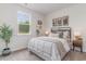 Comfortable bedroom featuring a large window, decorations, and a wooden nightstand at 384 Rookroost Circle, Conway, SC 29526