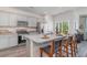 Open kitchen with a granite island, stainless steel appliances, gray cabinets, and barstool seating at 384 Rookroost Circle, Conway, SC 29526