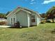 Well-maintained backyard with a concrete patio, green lawn, and side access, perfect for outdoor enjoyment at 3863 Stern Dr., Conway, SC 29526