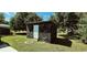 Backyard shed under construction, with RhinoRoof material, a white door, and a small fire pit nearby at 3863 Stern Dr., Conway, SC 29526