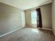 This cozy bedroom features a neutral color scheme, soft carpet, and ample natural light from the window at 3863 Stern Dr., Conway, SC 29526