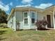 Detailed exterior view showing the light-colored siding, framed windows, and manicured garden bed at 3863 Stern Dr., Conway, SC 29526