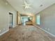 Open living room with neutral carpet, vaulted ceiling, and view into the kitchen and backyard through glass doors at 3863 Stern Dr., Conway, SC 29526