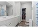 Bright bathroom with double vanity, large mirror, and walk-in closet at 3968 Hibiscus Dr., Little River, SC 29566