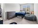 Comfortable bedroom with natural light, dresser and gray beanbag at 3968 Hibiscus Dr., Little River, SC 29566